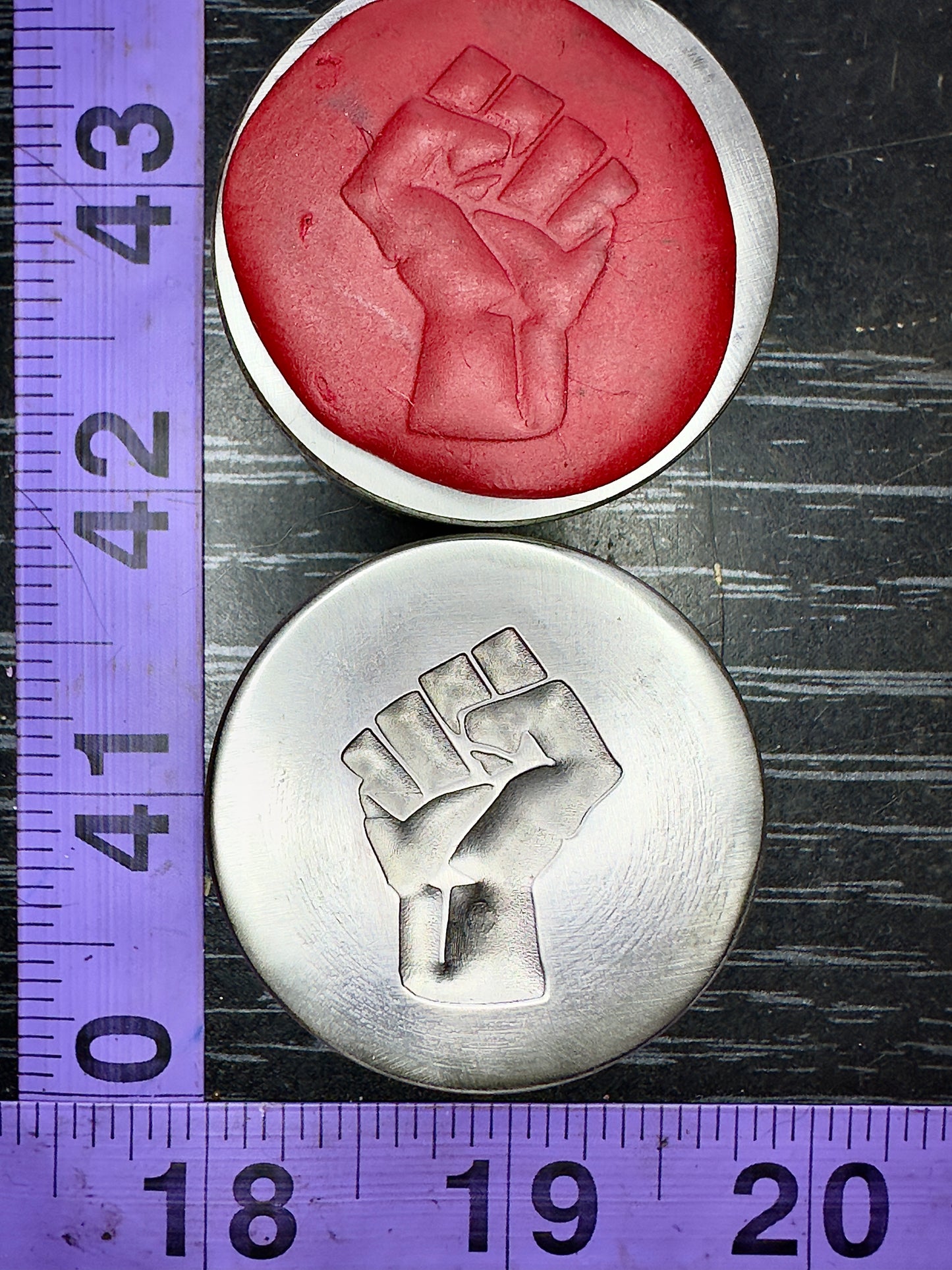 Raised fist, resist impression die