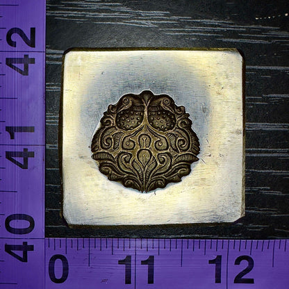 Mirrored peacocks impression die