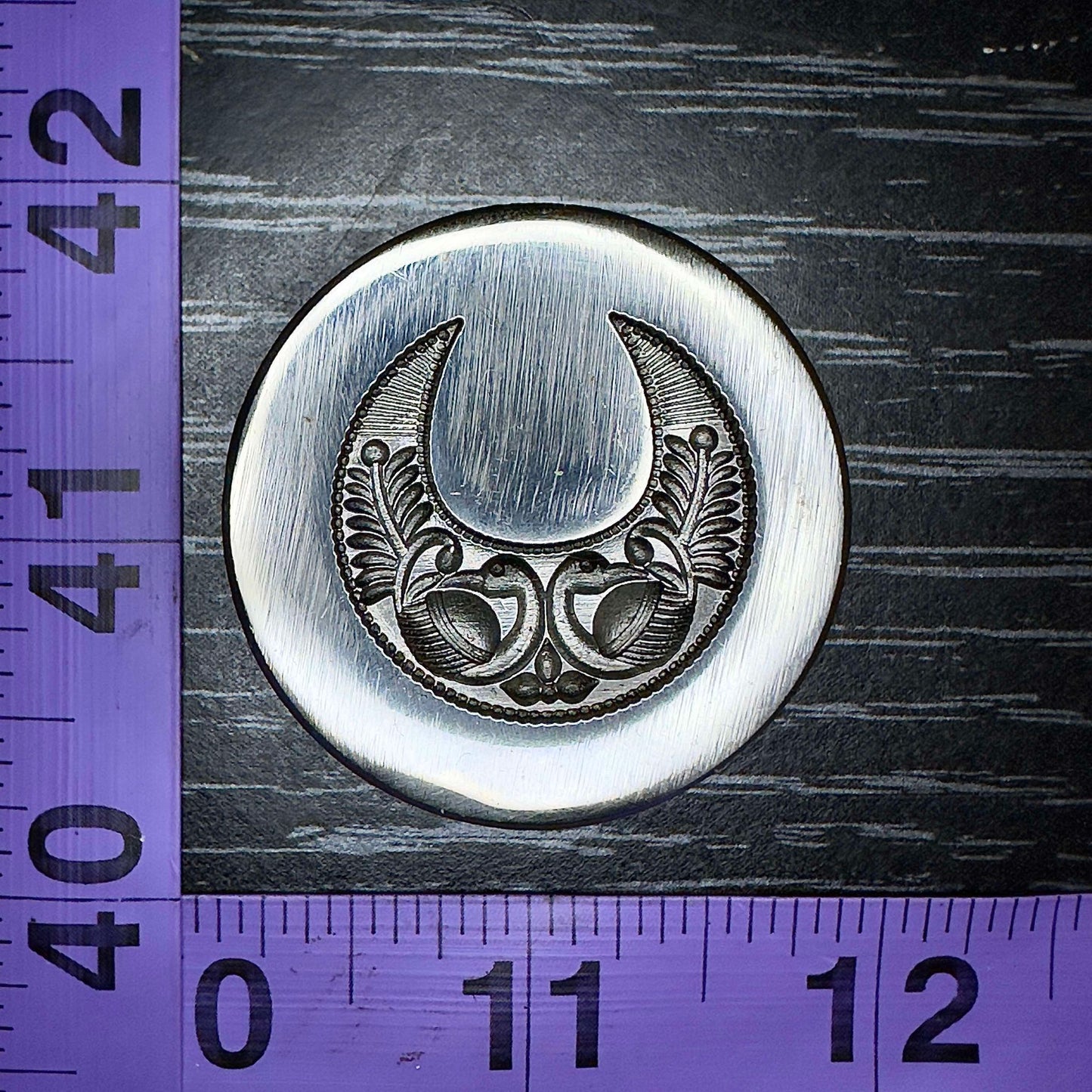 Mirrored peacocks impression die in a crescent moon